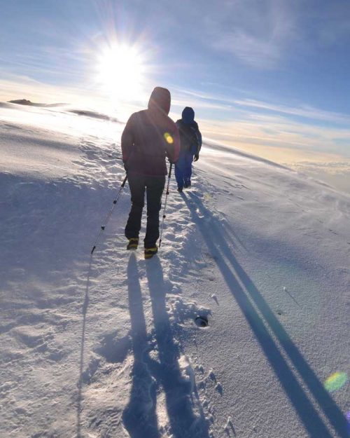 tourist hiking on snow ground