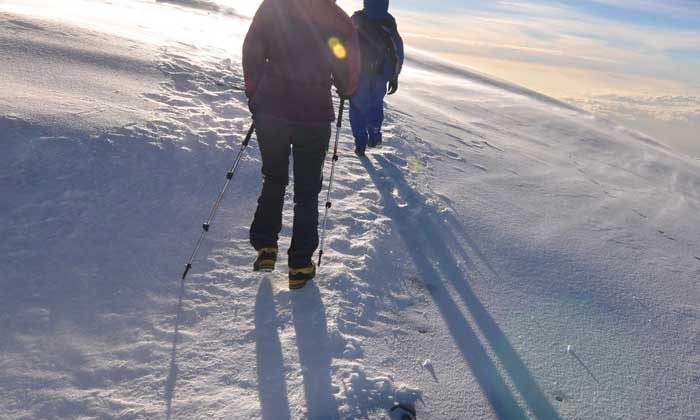 tourist hiking on snow ground