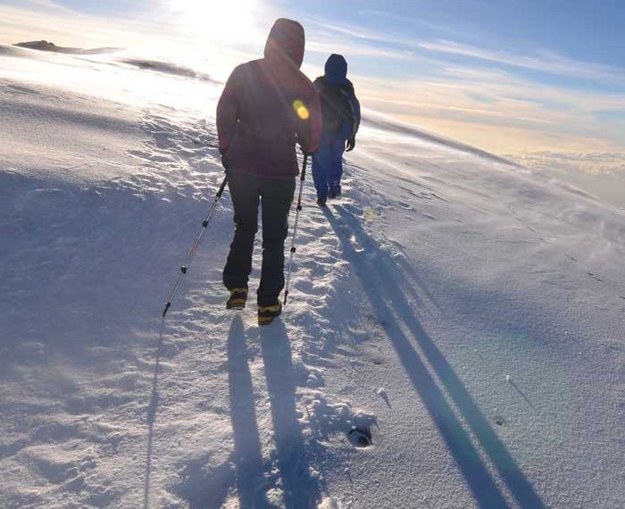 tourist hiking on snow ground